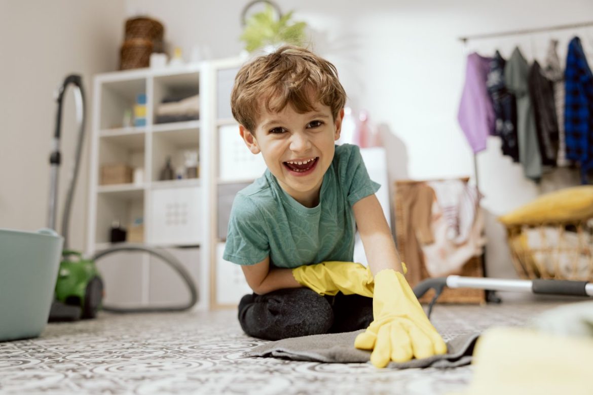 82baaef54595_a-little-smiling-boy-helps-parents-mop-the-floor-the-boy-lies-in-the-laundry-room-bathroom